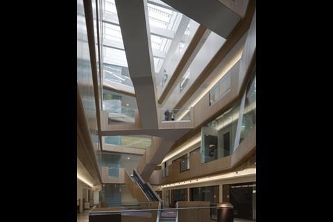 Staircases cut through the atrium in dramatic fashion, linking the six storeys and stimulating links between the occupants